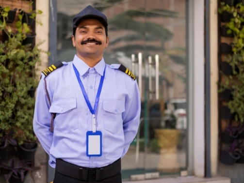 stock-photo-portrait-of-security-guard-with-hands-behind-back-while-working-at-gate-2451538717-coPsN3o1dG-transformed